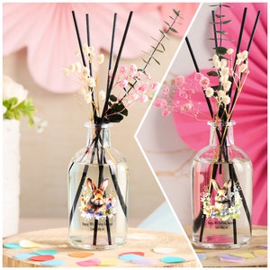 May include: A clear glass bottle diffuser with black reeds and dried flowers. The bottle has a personalised label with a cartoon bunny and the text "Happy 10th Birthday Emily Love Mummy xx".