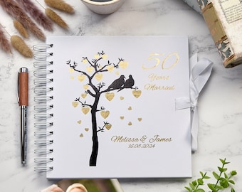 May include: White spiral bound journal with a gold foil design of a tree with hearts and two birds. The text "50 Years Married" and "Melissa & James 16.08.2024" is printed in gold foil.