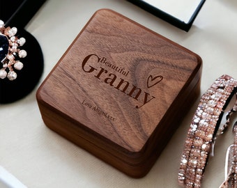 May include: A wooden box with the words "Beautiful Granny" engraved on the top. The box is closed and has a heart symbol next to the text. The text "Love Abigail xxx" is engraved on the bottom of the box.