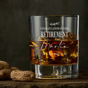 May include: A clear glass with a personalised message that reads "Congratulations on your Retirement Martin Love from the team". The glass is filled with amber liquid and ice cubes.