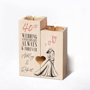 May include: Wooden candle holder with two candle wells. The holder is decorated with a couple dancing, hearts, and the text "40th Wedding Anniversary Always & Forever Ashley & Robert".