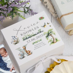 May include: A white keepsake box with a ribbon tie, personalised with the name "Xavier Knowles" and birth details. The box is decorated with watercolour illustrations of jungle animals, plants, and butterflies.