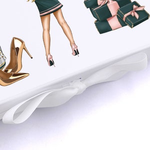Pu&ograve; includere: Una scatola regalo bianca con un nastro di raso bianco legato a fiocco. La scatola presenta un'illustrazione colorata di una donna con una gonna verde e tacchi alti dorati, e una pila di regali avvolti in carta rosa e verde.