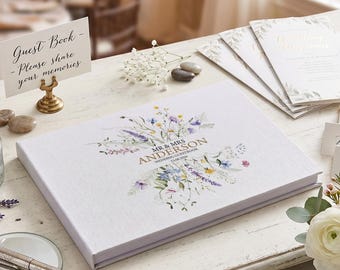 May include: A white wedding guest book with floral design and the text "MR & MRS ANDERSON WEDDING GUESTBOOK 23.06.2016". A sign reads "Guest Book - Please share your memories".