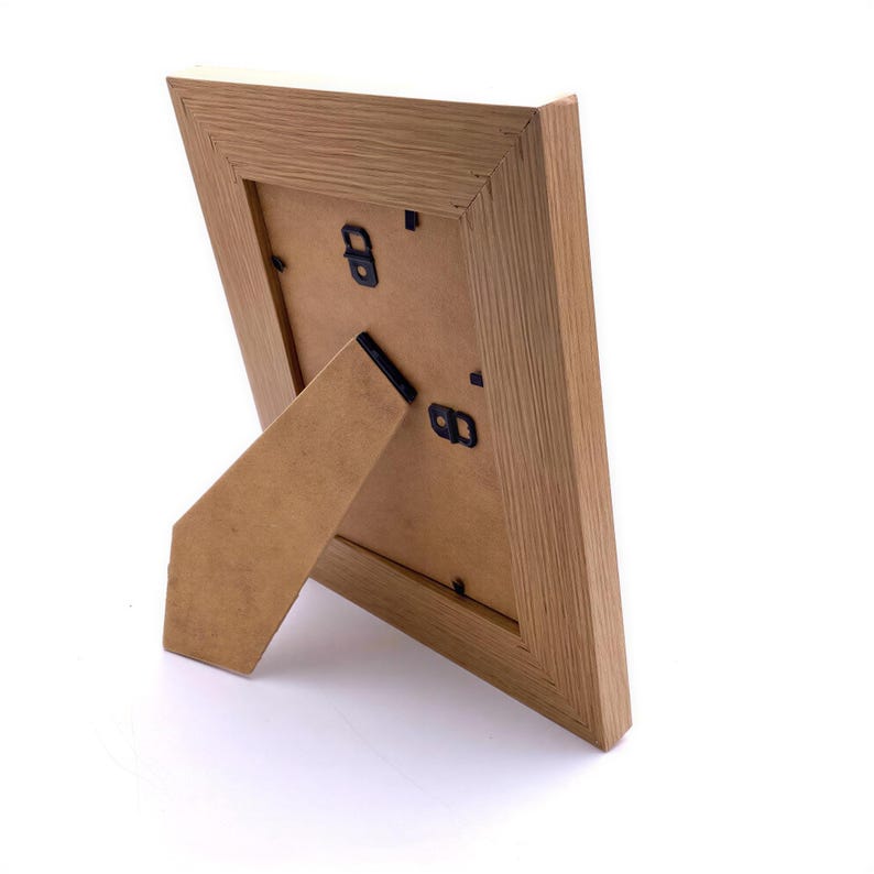 a wooden picture frame with a triangular shape and a wooden tail.