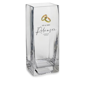 May include: Clear glass vase with a square base. The vase has a design of two gold rings and the text "MR & MRS Robinson MARRIED ON 30.08.2022".