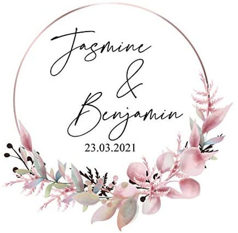May include: A wedding invitation with a delicate floral wreath in shades of pink and green. The text reads "Jasmine & Benjamin 23.03.2021".