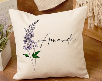 May include: A white pillow with a floral design and the name "Amanda" in black script.