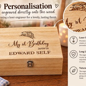 a wooden box with a personalized engraving on it, placed on a wooden surface. The box has a laser engraver on it, which has engraved the text "My first birthday 26.09.18 EDWARD SELF" on it. The box is described as a "Personalised" and "Laser Engraved" item, and it is shown as a "Natural & Beautiful" gift. The image also includes a close-up of the engraving, highlighting the laser engraving process and the final product.