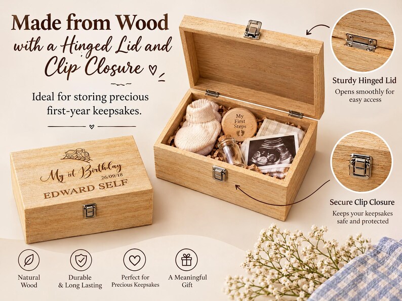 a wooden box with a hinged lid and clip closure, designed for storing first-year keepsakes. The box is made of natural wood and has a sturdy hinge for easy closure. It contains a photo of a baby's feet, a memento, and a card. The box is described as ideal for storing precious first-year keepsakes and is made from natural wood, ensuring durability and long-lasting quality. The box also has a secure clip closure to keep the contents safe and protected.