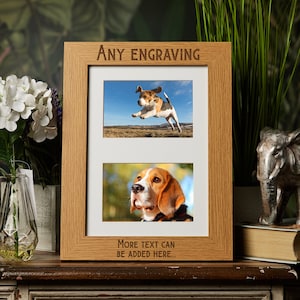 May include: A wooden photo frame with two openings for pictures. The frame is light brown and has the words "ANY ENGRAVING" engraved on the top. The frame is sitting on a table with a book and a decorative elephant figurine.