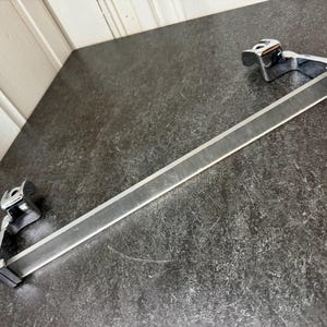 May include: A set of three ceramic mugs with a speckled, matte finish. The mugs are in shades of cream, light gray, and dark gray. Each mug has a simple, minimalist design, perfect for coffee or tea.