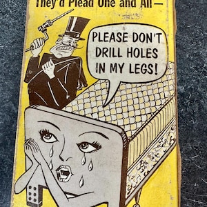 May include: Vintage yellow box with a cartoon illustration. The image features a bed with a crying face, a man with a drill, and the text "PLEASE DON'T DRILL HOLES IN MY LEGS!" The box has the text "If Beds Could Talk, They'd Plead One and All-"