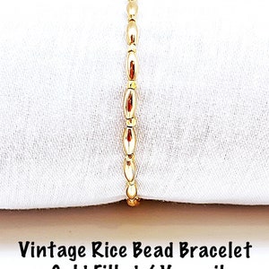May include: A gold-filled vintage rice bead bracelet. The bracelet is made of small, oval-shaped beads.