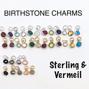 May include: Birthstone charms in sterling silver and vermeil. The charms feature a variety of colored gemstones, including red, purple, blue, green, white, and yellow.