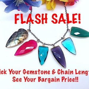 May include: A black chain necklace with a variety of gemstone pendants, including green, blue, purple, pink, and grey. The text "FLASH SALE!" is displayed above the necklace. The text "Pick Your Gemstone & Chain Length See Your Bargain Price!!" is displayed below the necklace.