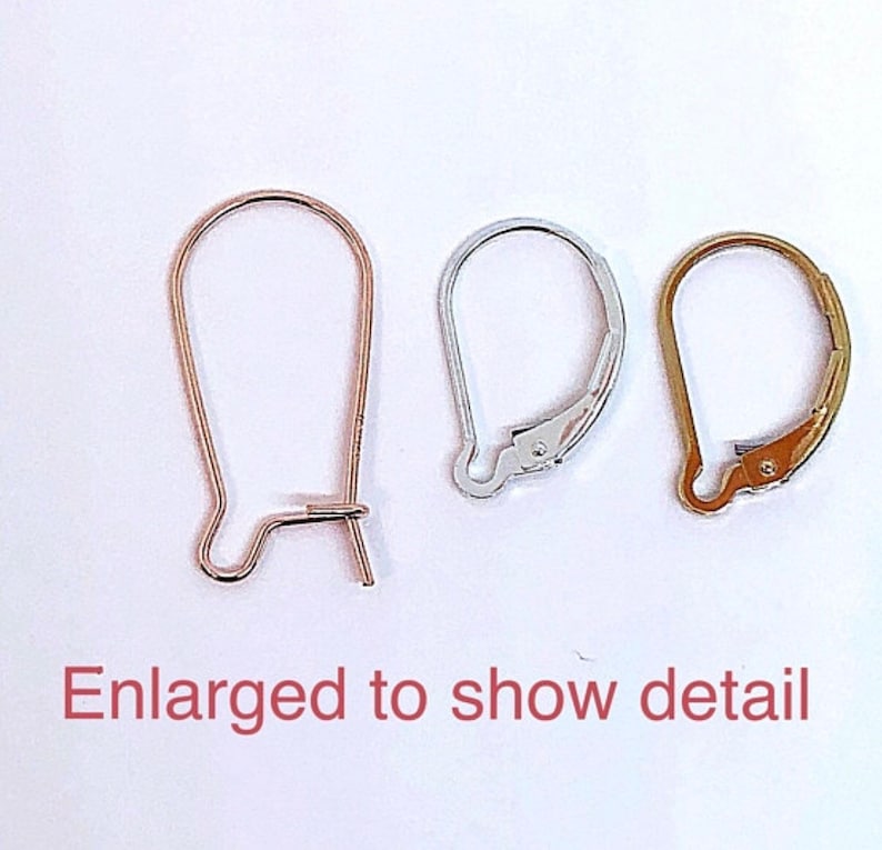 May include: Three earring hooks in different finishes: gold, silver, and rose gold. The hooks are enlarged to show detail.