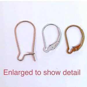 May include: Three earring hooks in different finishes: gold, silver, and rose gold. The hooks are shown enlarged to show detail.