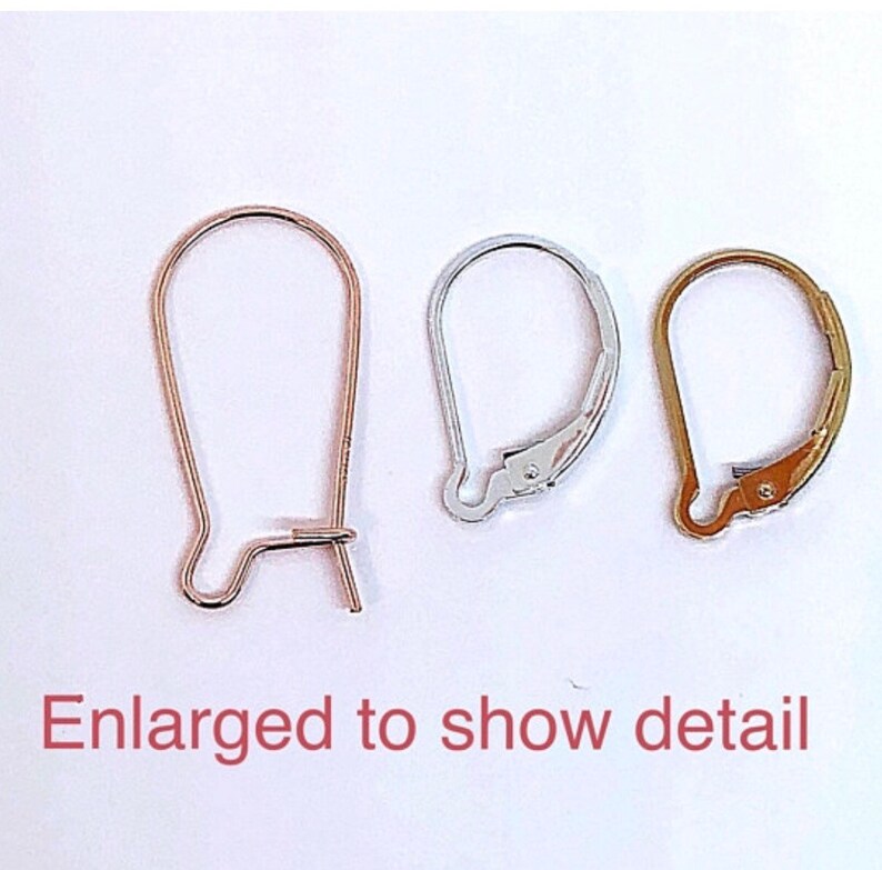 May include: Three earring hooks in different finishes: gold, silver, and rose gold. The hooks are shown enlarged to show detail.