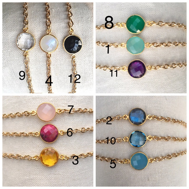 May include: Twelve gold chain bracelets with different colored gemstone beads. The beads are in various shades of blue, green, pink, red, and purple. The bracelets are numbered 1 through 12.