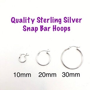 May include: Three silver hoop earrings with snap bar closures. The hoops are 10mm, 20mm, and 30mm in diameter.