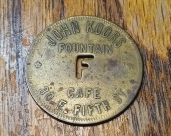 John Koors Fountain Cafe 30 E. Fifth St., Good For 5 Cents In Trade Token