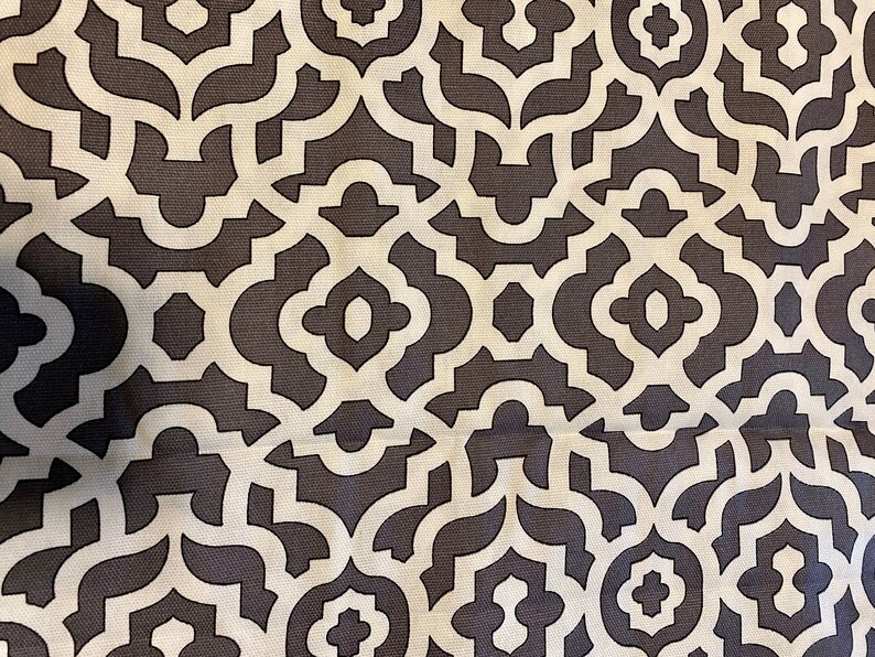 May include: A white and dark gray geometric pattern fabric with a repeating design of interlocking shapes.
