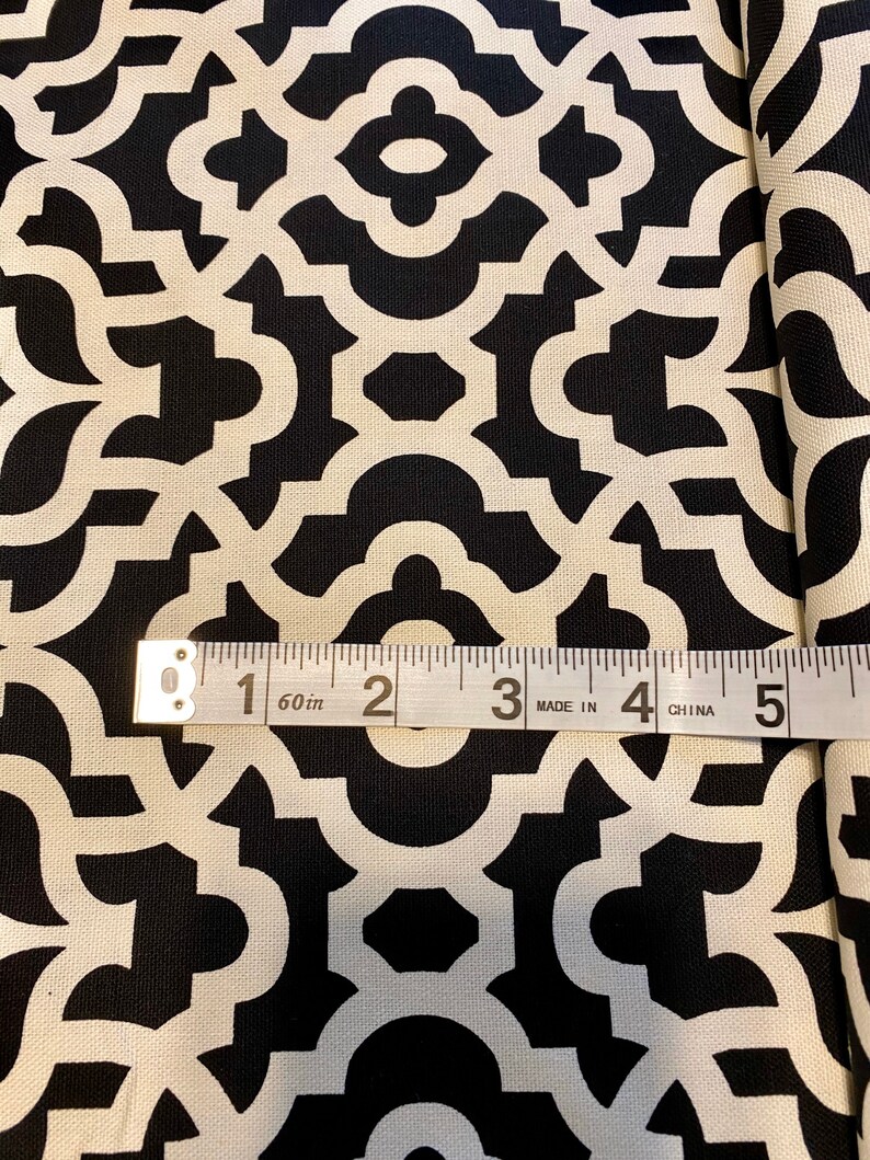 May include: Black and white fabric with a geometric pattern. A measuring tape reads "60 in" and shows 5 inches.
