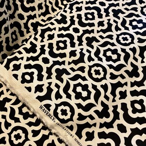 May include: Black and white fabric with a geometric pattern. The fabric has the text "Waverly Inspirations Screen Print" on the edge.