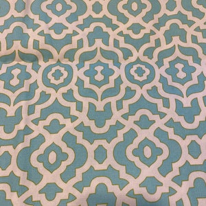 May include: A blue and white fabric with a geometric pattern. The pattern is made up of repeating squares and circles.