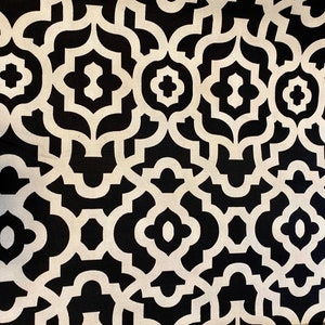 May include: Black and white geometric fabric with a repeating pattern of interlocking shapes. The fabric has a subtle sheen and a smooth texture.