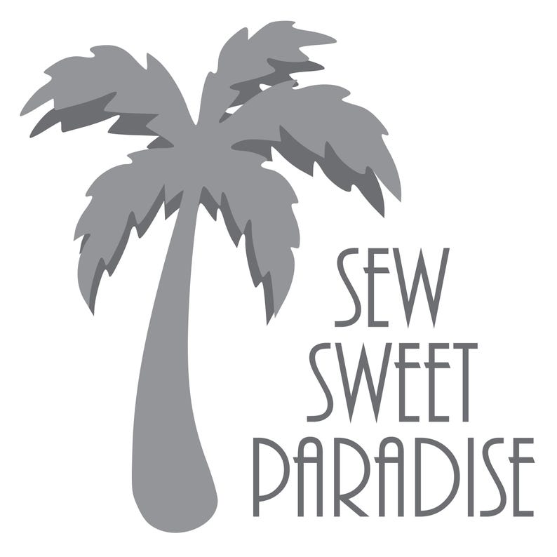 May include: A gray illustration of a palm tree with the text "SEW SWEET PARADISE" in a stylized font. The palm tree is centered, with the text to the right. The image is on a white background.