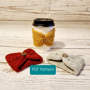 May include: Three knitted coffee cup cozies in red, mustard yellow, and gray with a decorative button on each. The text "PDF Pattern" is printed on a teal background.