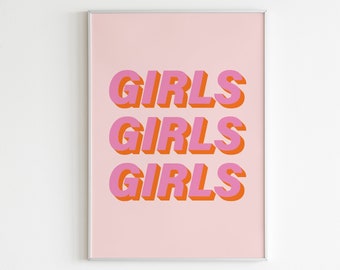 May include: A pink and orange print with the word "GIRLS" repeated three times in a bold, 3D-style font. The print is framed in a silver frame and is hanging on a white wall.