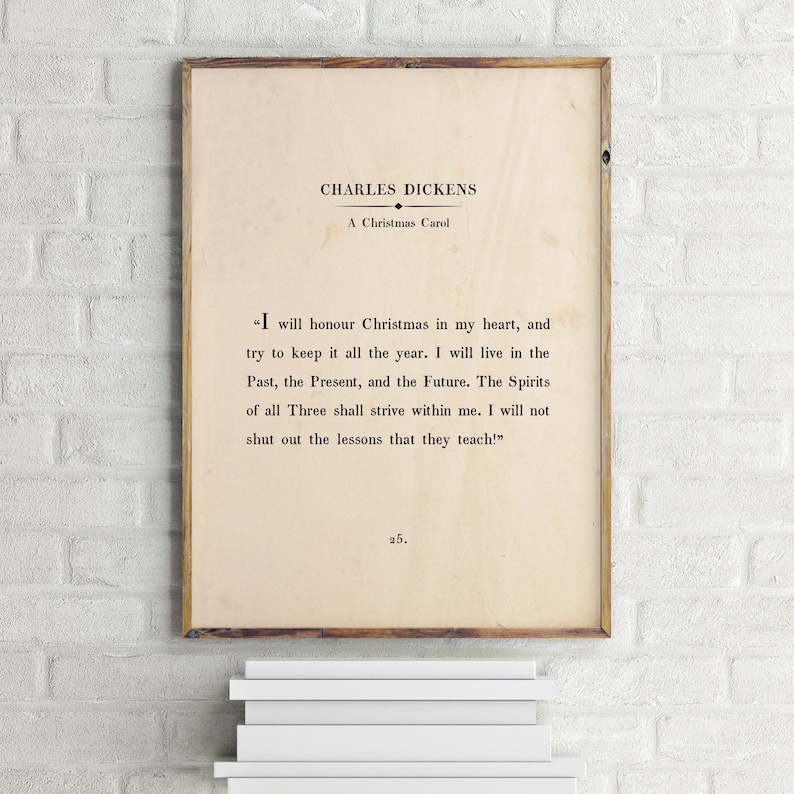 May include: A vintage-style print of a quote from Charles Dickens's "A Christmas Carol." The quote reads, "I will honour Christmas in my heart, and try to keep it all the year. I will live in the Past, the Present, and the Future. The Spirits of all Three shall strive within me. I will not shut out the lessons that they teach!" The print is on a cream-coloured background with black text.