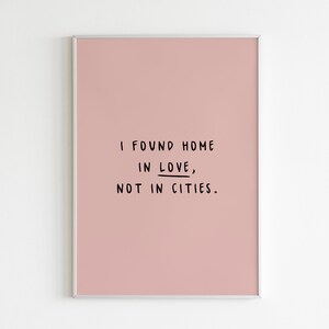 May include: A pink framed print with the text "I found home in love, not in cities."