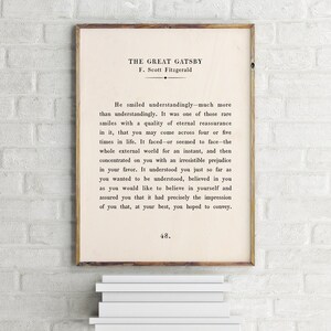 May include: A black and white printable poster featuring a quote from "The Great Gatsby" by F. Scott Fitzgerald. The quote reads: "He smiled understandingly-much more than understandingly. It was one of those rare smiles with a quality of eternal reassurance in it, that you may come across four or five times in life. It faced-or seemed to face-the whole external world for an instant, and then concentrated on you with an irresistible prejudice in your favor. It understood you just so far as you wanted to be understood, believed in you as you would like to believe in yourself and assured you that it had precisely the impression of you that, at your best, you hoped to convey." The page number 48 is at the bottom of the poster.