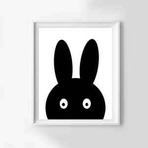 May include: Black and white illustration of a rabbit's face with large ears and two white eyes.