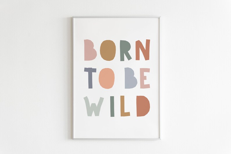 May include: A framed print with the text "BORN TO BE WILD" in colorful, cut-out letters. The letters are in shades of pink, brown, green, blue, and orange.