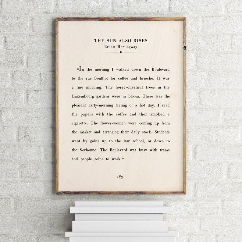 May include: A vintage book cover with the title "The Sun Also Rises" by Ernest Hemingway. The text on the cover is a passage from the book describing a morning in Paris.