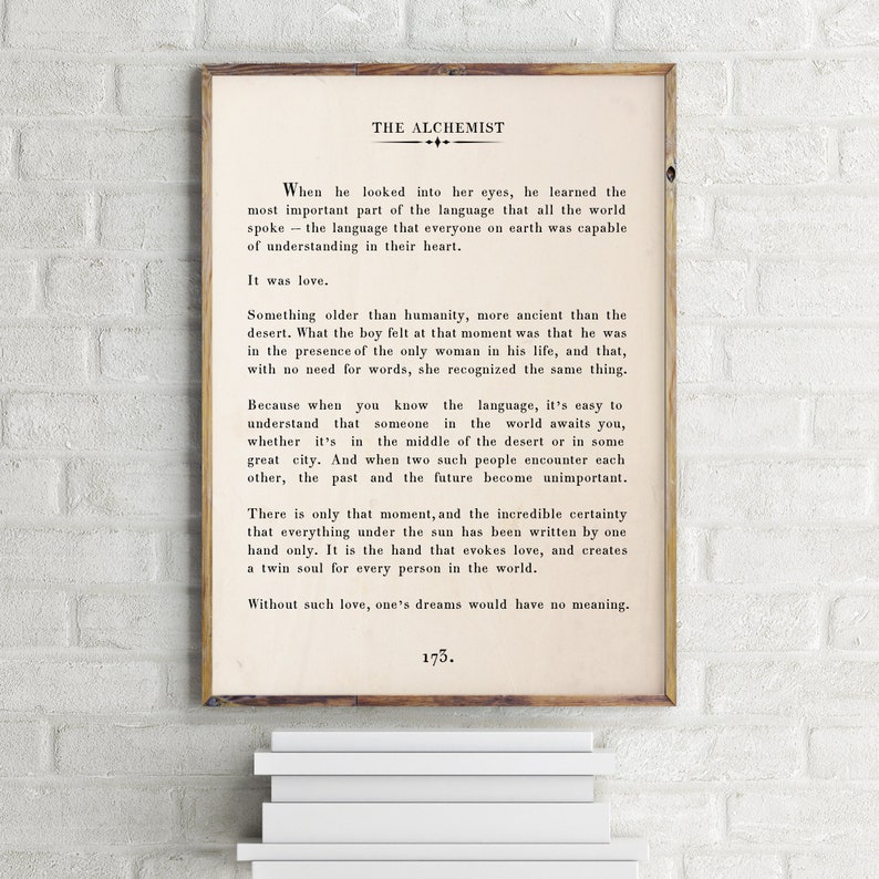 May include: A vintage-style print of a page from "The Alchemist" by Paulo Coelho. The text discusses the importance of love and how it transcends language and time. The page number is 173.