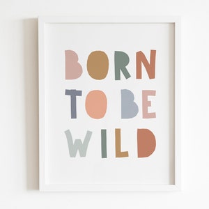 May include: A framed print with the text "BORN TO BE WILD" in colorful, stylized letters. The letters are in shades of pink, brown, green, blue, and orange.
