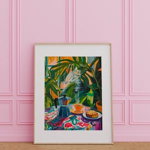May include: A framed painting of a still life with a coffee pot, a cup of coffee, and a pastry on a colorful tablecloth. The background features lush green plants and a window with sunlight streaming through.