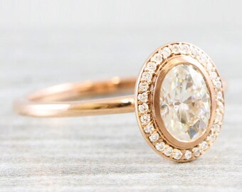 Oval moissanite and diamond halo engagement ring handmade in 14 carat rose/white/yellow gold