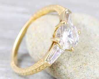 Moissanite engagement ring handmade in 14 carat yellow gold with baguette accent stones