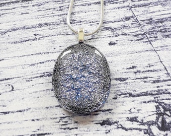 Silver dichroic glass pendant, bright, sparkly oval pendant with a slight lavender tint.