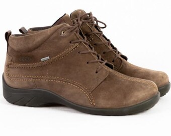 May include: Brown leather ankle boots with laces. The boots have a rounded toe, a low heel, and a textured sole. The stitching is visible, and the boots appear to be waterproof. The boots are a neutral color and suitable for various outfits.