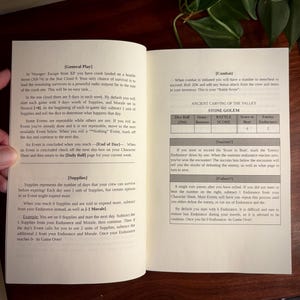 May include: An open instructional booklet for a tabletop game titled Voyager: Escape from X8. The left page details General Play and Supplies, while the right page outlines Combat mechanics, including a table for the Stone Golem enemy with stats.