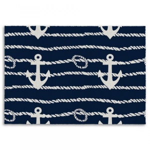 May include: A navy blue rug with a white rope pattern and white anchor designs.