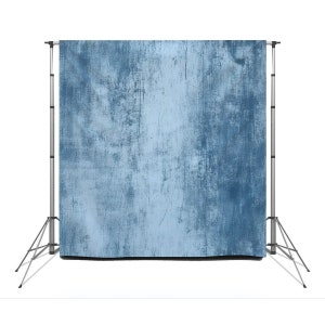 May include: A blue backdrop with a distressed, textured look, perfect for photography or video backdrops.